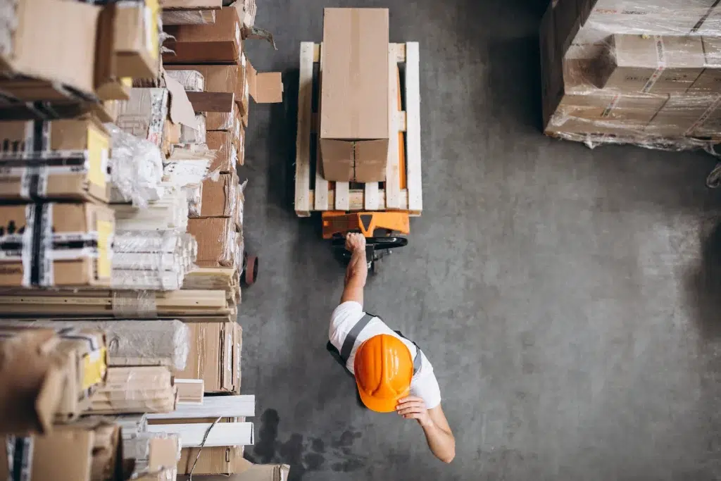 young-man-working-warehouse-with-boxes-scaled